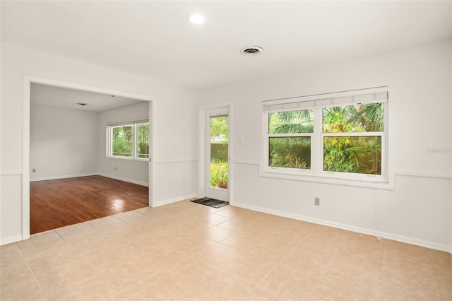 spare room with recessed lighting, baseboards, and visible vents