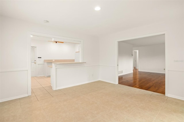 spare room featuring light tile patterned floors, baseboards, recessed lighting, and a ceiling fan