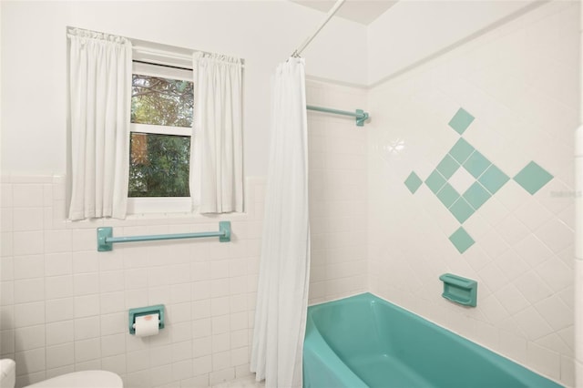 full bath with tile walls, toilet, and shower / bathtub combination with curtain