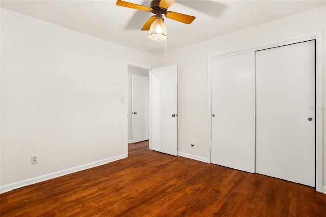 unfurnished bedroom with wood finished floors, baseboards, a closet, and ceiling fan