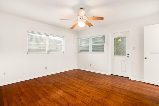 spare room featuring a ceiling fan, wood finished floors, and baseboards