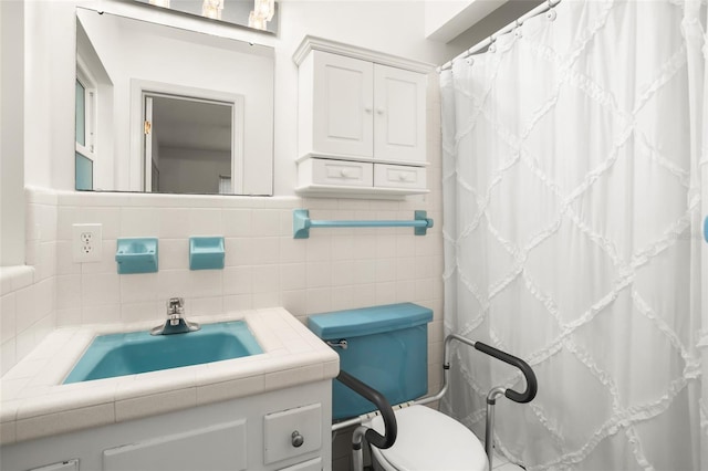 bathroom featuring curtained shower, toilet, tile walls, and vanity