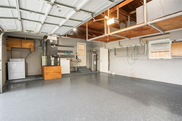 garage with a sink, electric water heater, washer / dryer, and a garage door opener