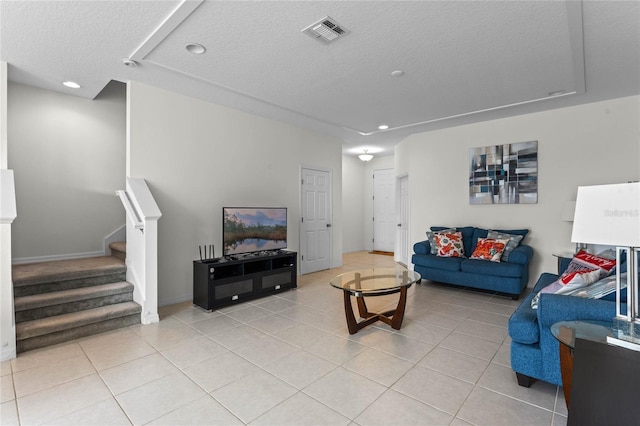 tiled living room with a textured ceiling