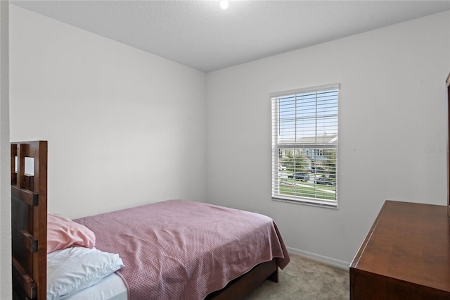 bedroom featuring light carpet