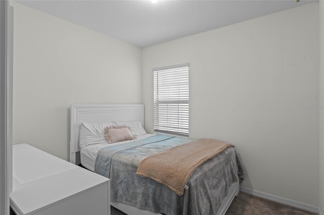 carpeted bedroom featuring a textured ceiling