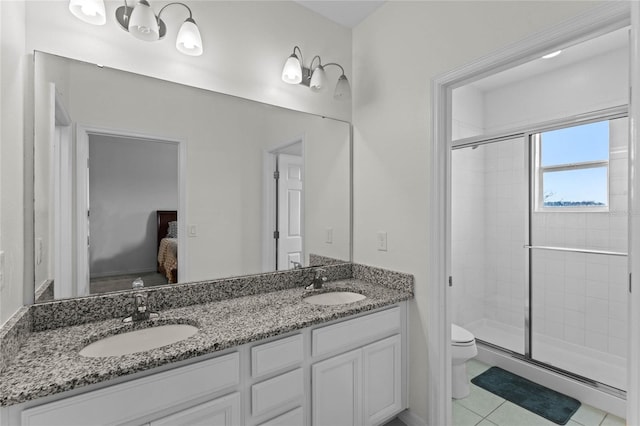 bathroom featuring tile patterned flooring, vanity, toilet, and walk in shower