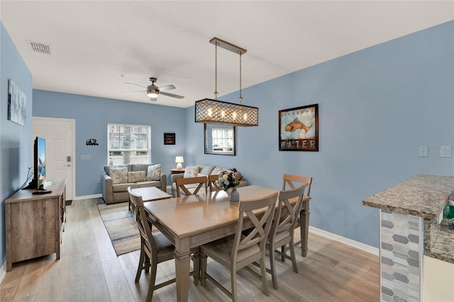 dining area with ceiling fan and light hardwood / wood-style flooring