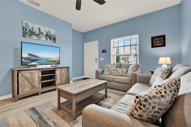 living room featuring ceiling fan and light wood-type flooring