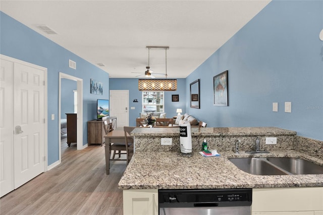 kitchen with white cabinets, light stone countertops, and dishwasher