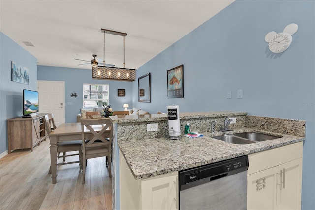 kitchen featuring pendant lighting, sink, light hardwood / wood-style flooring, white cabinets, and stainless steel dishwasher