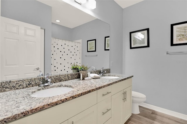 bathroom with walk in shower, vanity, toilet, and hardwood / wood-style floors