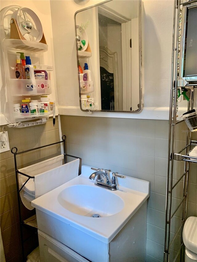 bathroom featuring tile walls and vanity