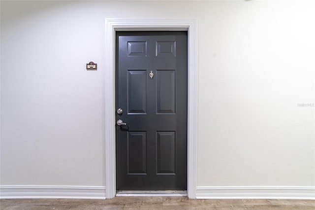 doorway to property featuring stucco siding