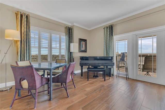 dining room with crown molding, plenty of natural light, and hardwood / wood-style floors