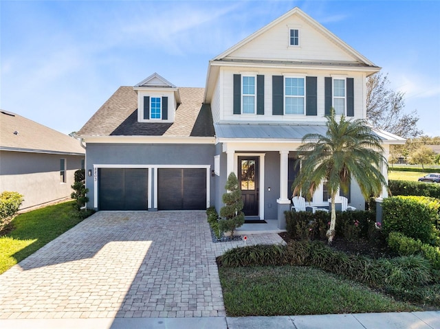 view of front of home with a porch and a garage