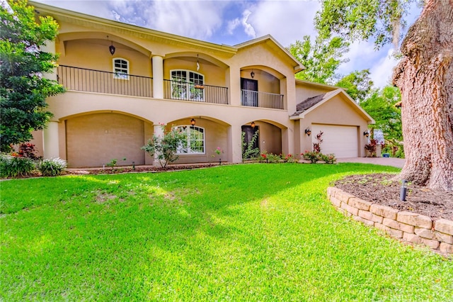 view of front of house with a garage, a balcony, and a front lawn