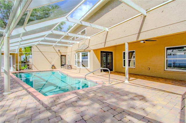 view of pool with a lanai, a patio, and french doors