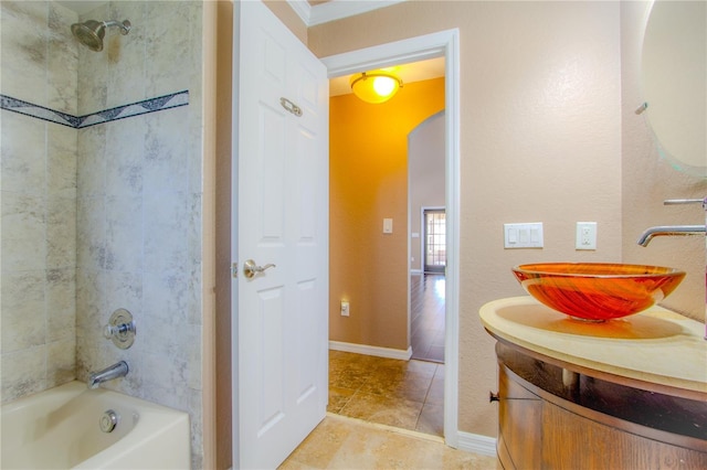 bathroom with tiled shower / bath, vanity, and tile patterned floors