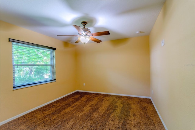 spare room featuring ceiling fan and carpet