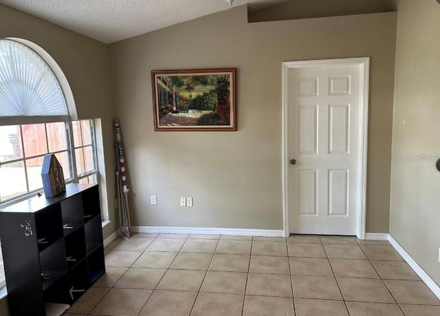 interior space featuring vaulted ceiling and a textured ceiling