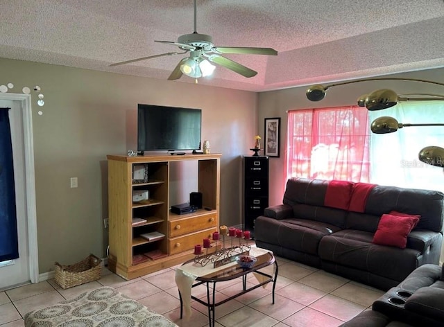 tiled living room featuring ceiling fan and a textured ceiling