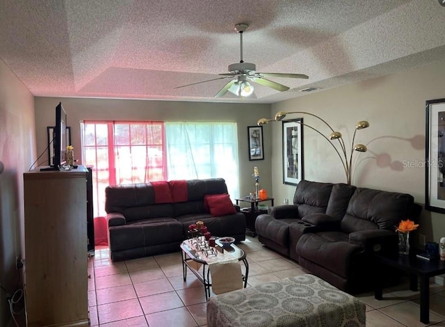 tiled living room featuring ceiling fan and a textured ceiling