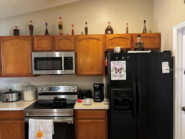 kitchen featuring lofted ceiling and appliances with stainless steel finishes