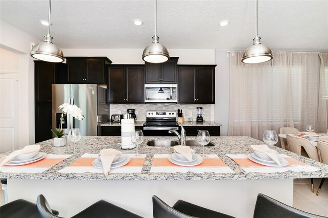 3373 Lilac Way, Davenport, FL 33897 - kitchen with pendant lighting, appliances with stainless steel finishes, sink, and tasteful backsplash