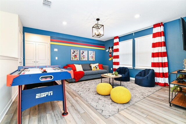 3373 Lilac Way, Davenport, FL 33897 - recreation room with a notable chandelier and light wood-type flooring