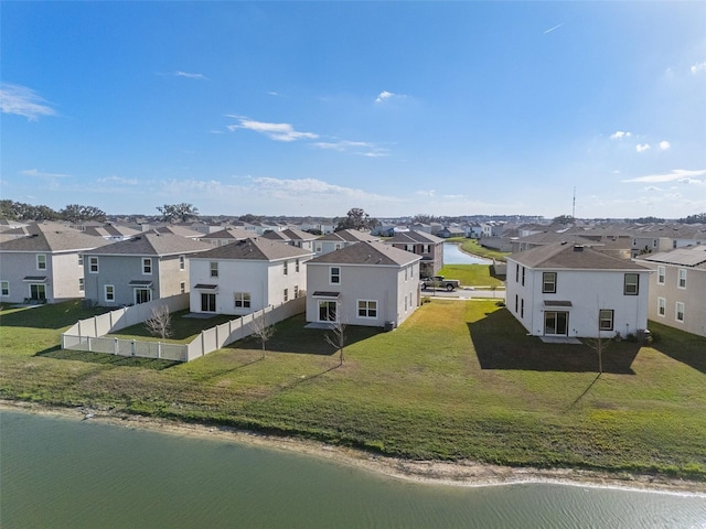 birds eye view of property with a water view and a residential view