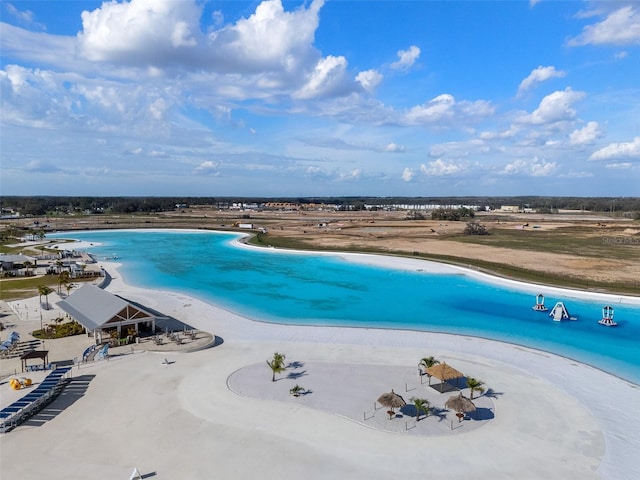 aerial view featuring a water view and a view of the beach