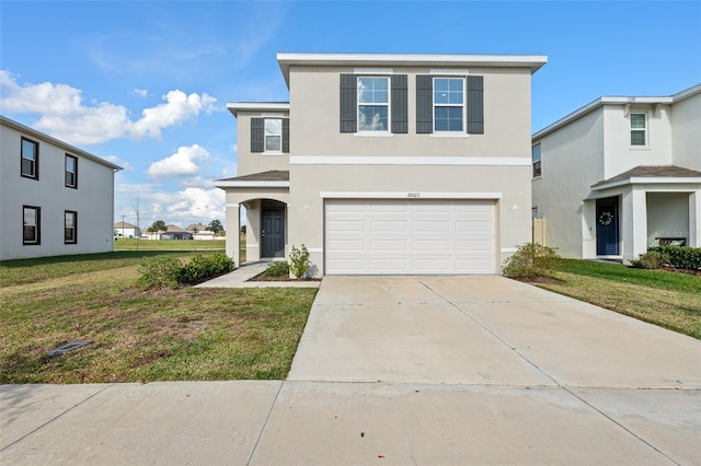 view of front of home with a garage, a front lawn, concrete driveway, and stucco siding