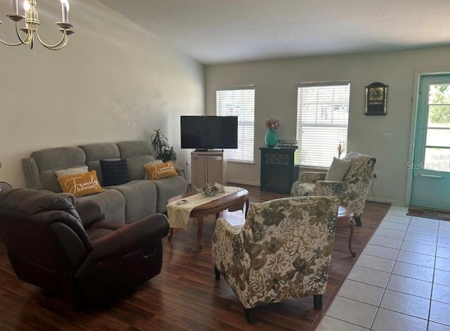 living room featuring a chandelier and tile patterned flooring