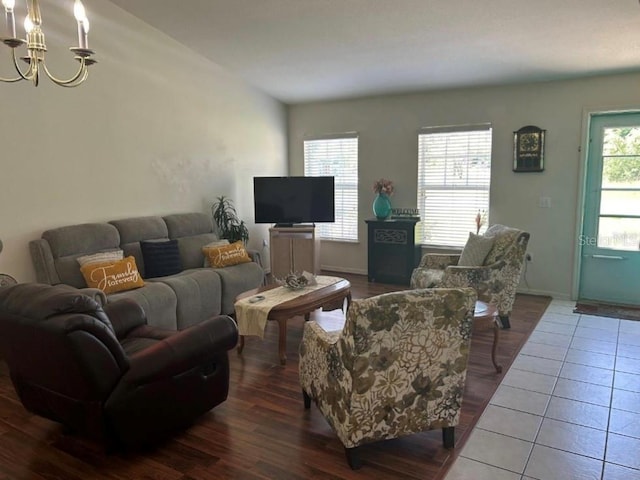 tiled living room featuring a chandelier