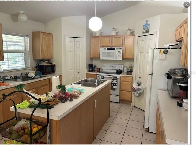 kitchen with sink, hanging light fixtures, white appliances, and light tile patterned floors