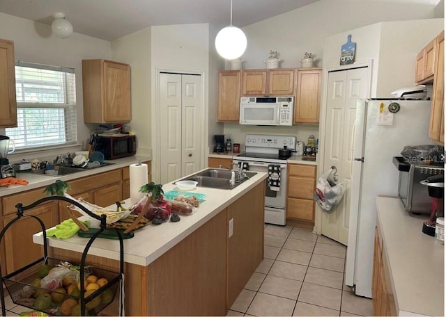 kitchen with light tile patterned flooring, sink, hanging light fixtures, a kitchen island with sink, and white appliances