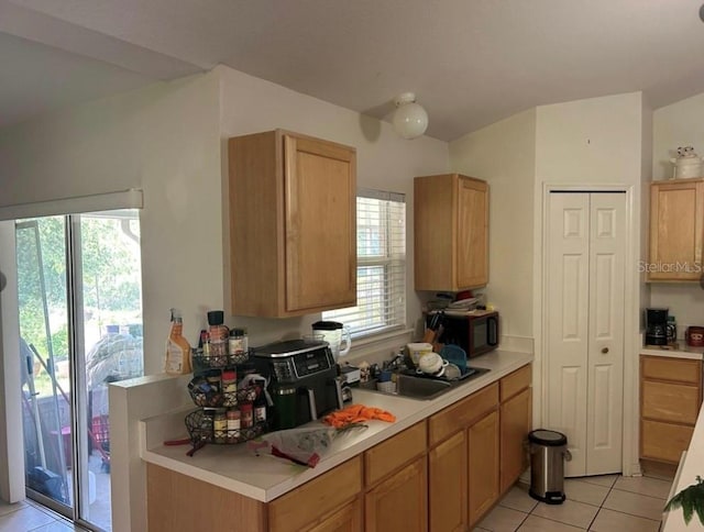 kitchen with light tile patterned flooring and sink