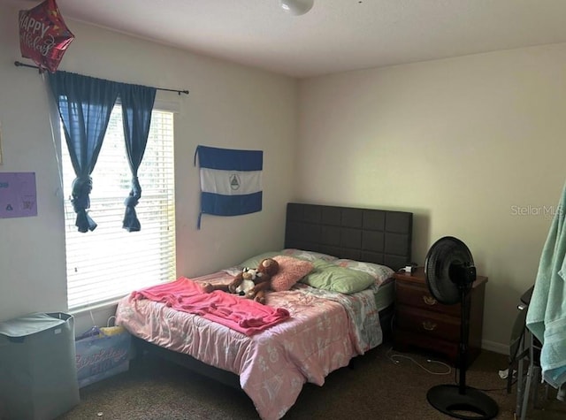 bedroom featuring dark carpet