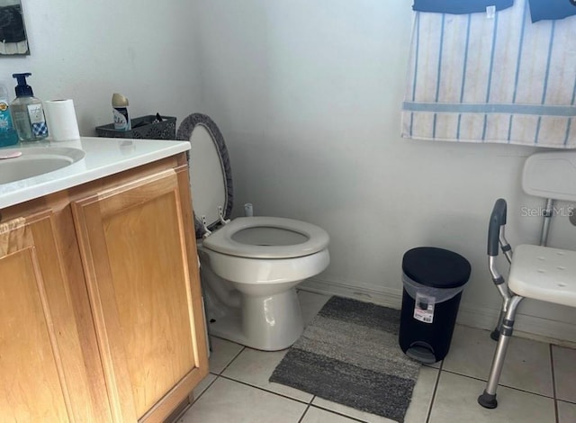 bathroom featuring vanity, toilet, and tile patterned flooring