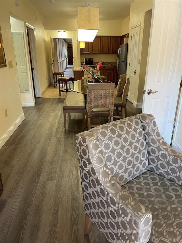 living room featuring dark wood-style floors and baseboards