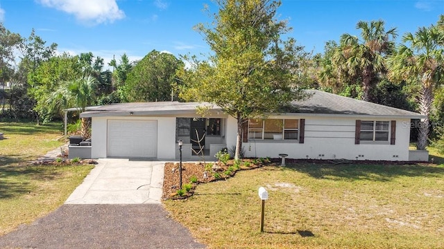 ranch-style house featuring a front lawn, an attached garage, driveway, and crawl space