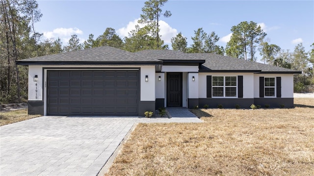 view of front of house with a garage and a front yard