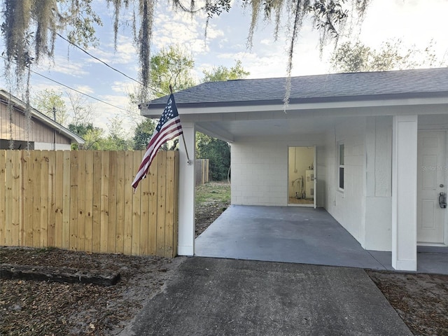 view of car parking featuring a carport and water heater