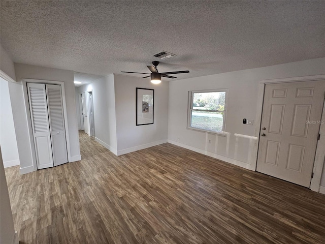 unfurnished living room with hardwood / wood-style flooring, a textured ceiling, and ceiling fan