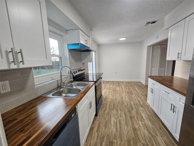 kitchen featuring butcher block counters, sink, stainless steel electric range, black dishwasher, and white cabinets