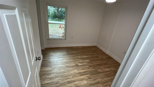 unfurnished room featuring dark wood-type flooring