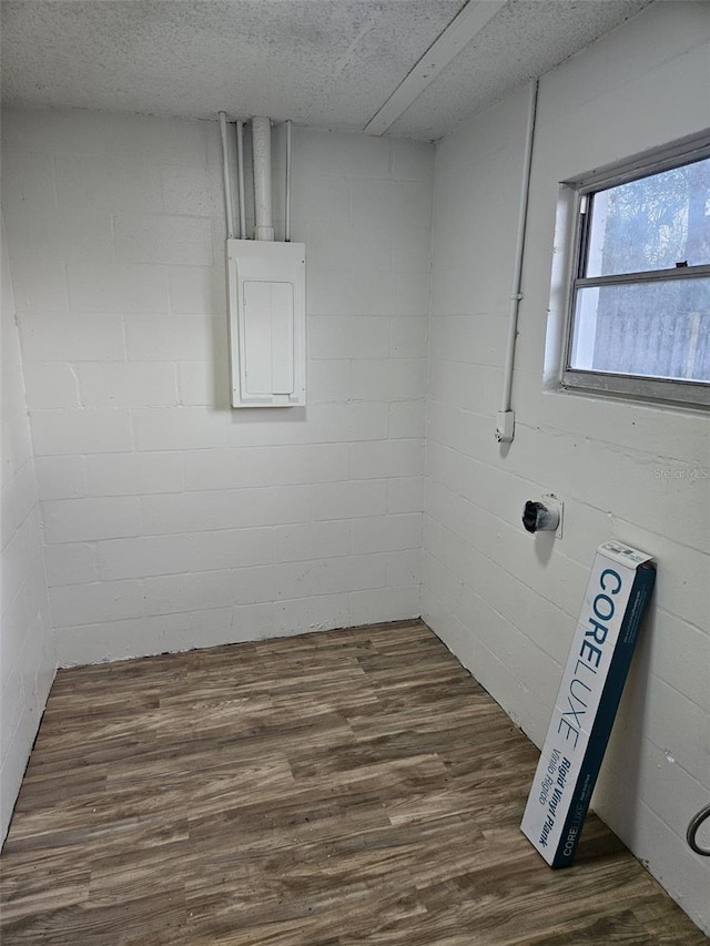 interior space with dark hardwood / wood-style flooring and electric panel