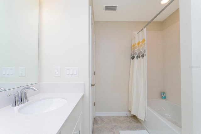 bathroom featuring tile patterned floors, shower / tub combo, and vanity