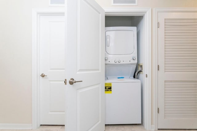 washroom featuring stacked washer / dryer